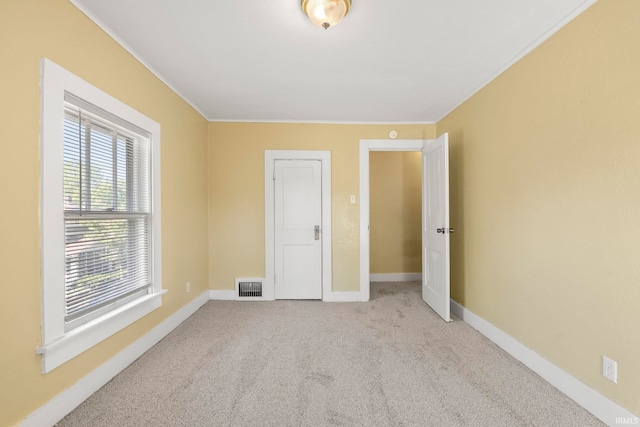 unfurnished bedroom with light carpet and ornamental molding