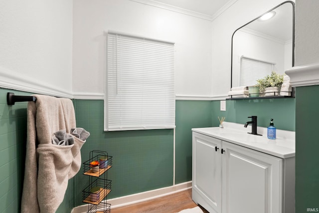 bathroom featuring hardwood / wood-style floors, vanity, tile walls, and crown molding