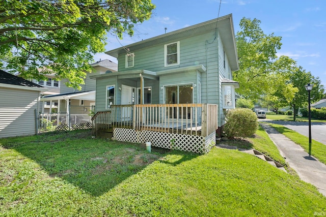 back of house with a lawn