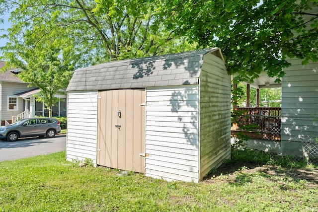 view of outbuilding with a yard