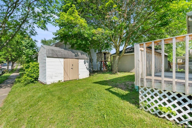 view of yard with a deck and a storage shed