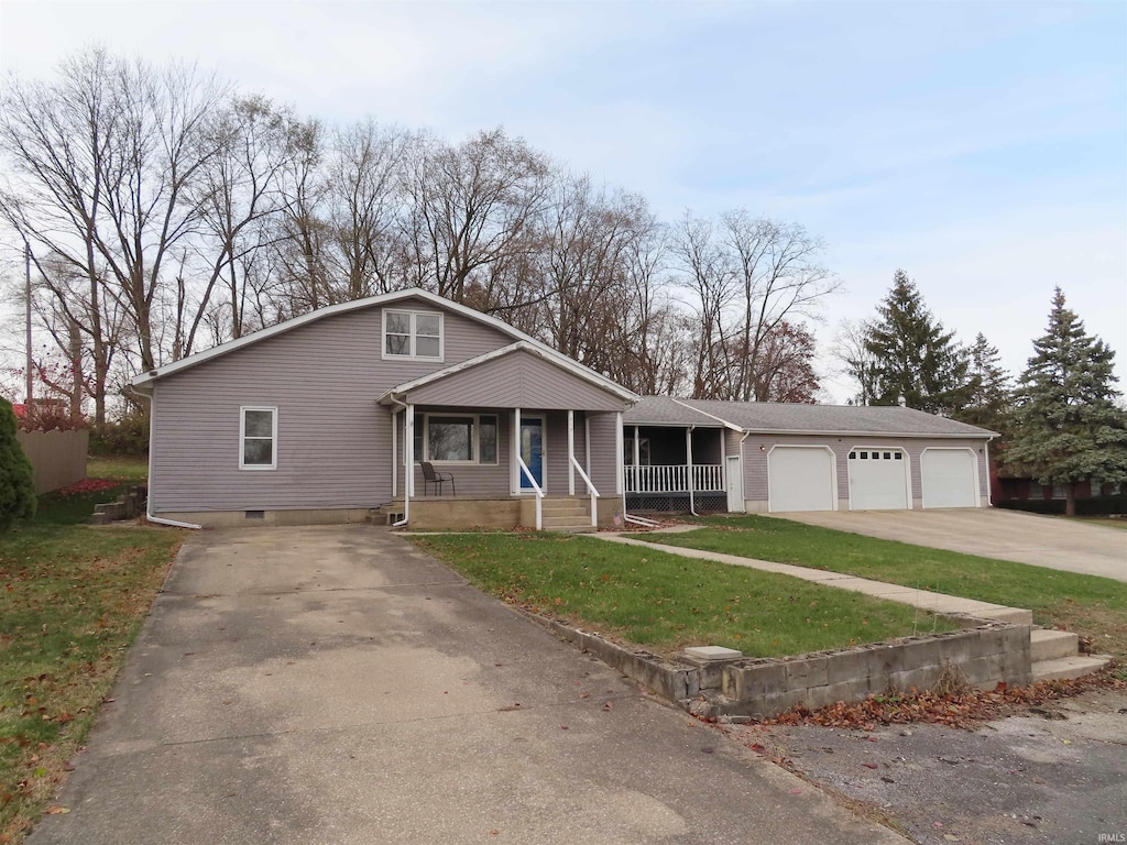 view of front of home featuring a garage, covered porch, and a front lawn