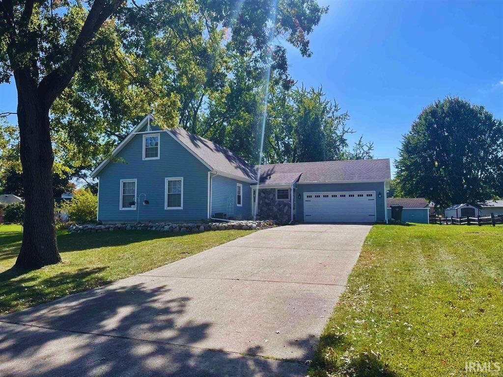 view of front of house with a front yard and a garage