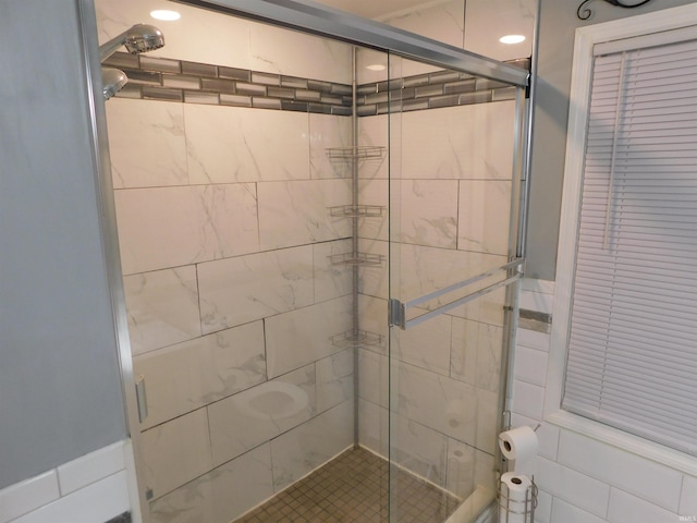 bathroom featuring a shower with shower door