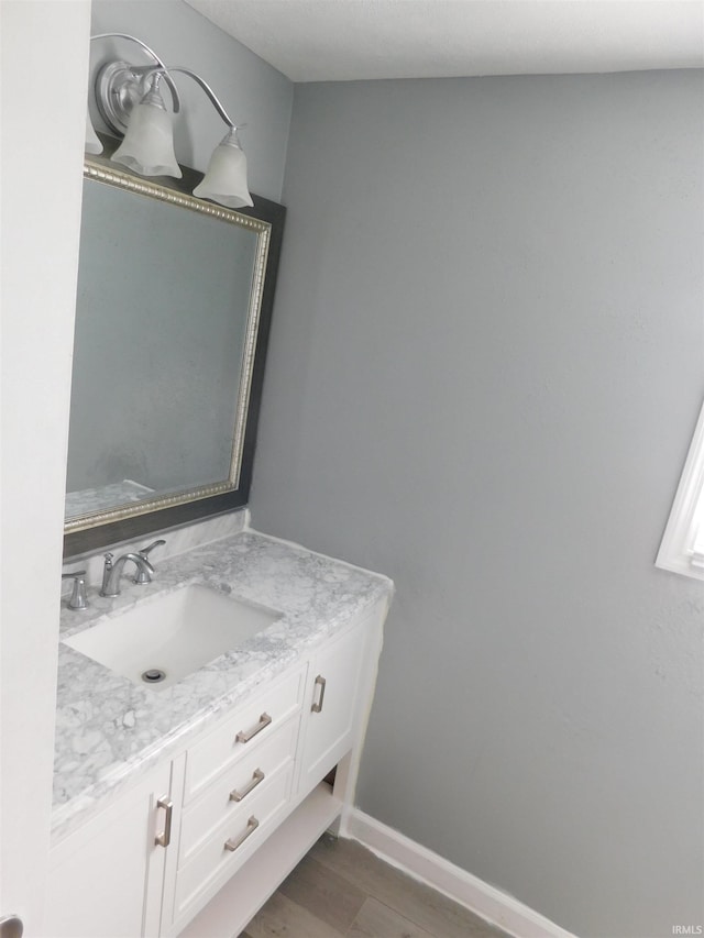 bathroom with vanity and wood-type flooring