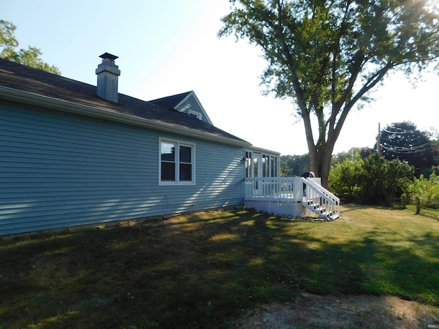 view of property exterior featuring a yard and a deck