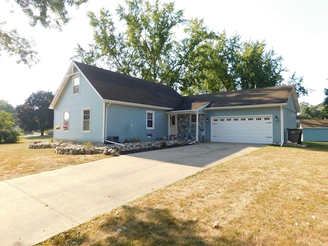 view of front of property with a front lawn and a garage