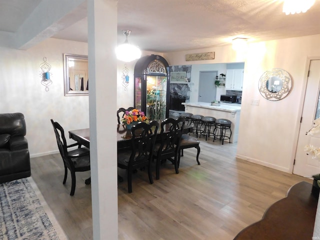 dining space with light hardwood / wood-style floors