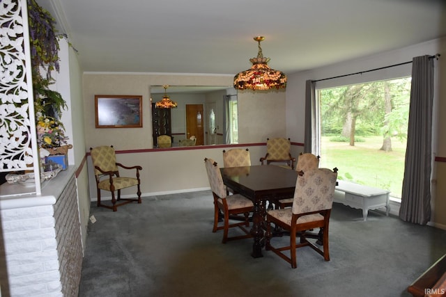 dining area featuring dark colored carpet and ornamental molding