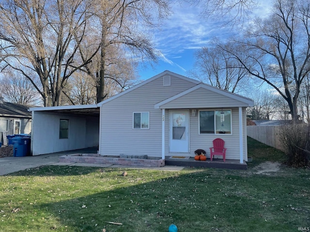 view of front of home with a front lawn and a carport