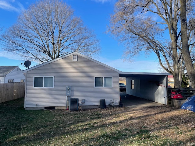 back of house featuring a carport and central air condition unit