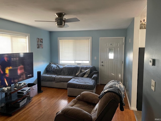 living room with wood-type flooring and ceiling fan