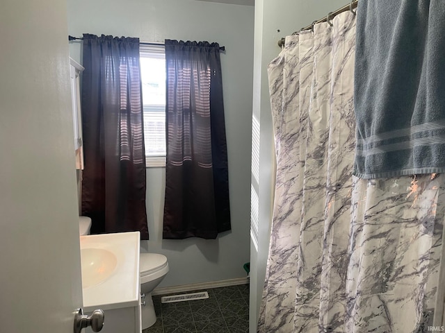 bathroom featuring tile patterned flooring, vanity, and toilet