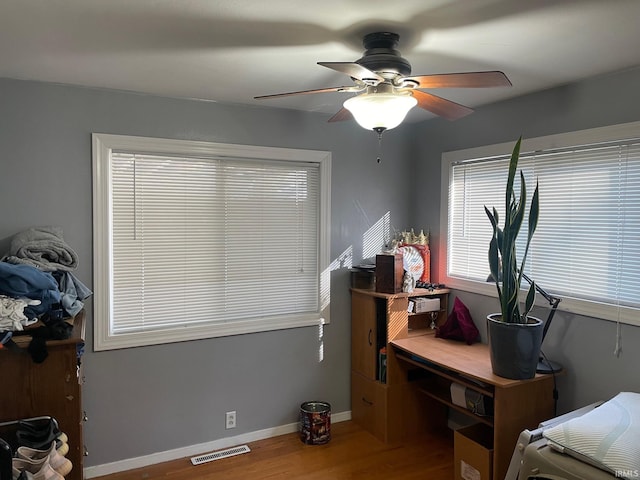 bedroom with hardwood / wood-style flooring and ceiling fan