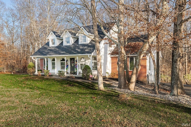 cape cod house with covered porch and a front lawn