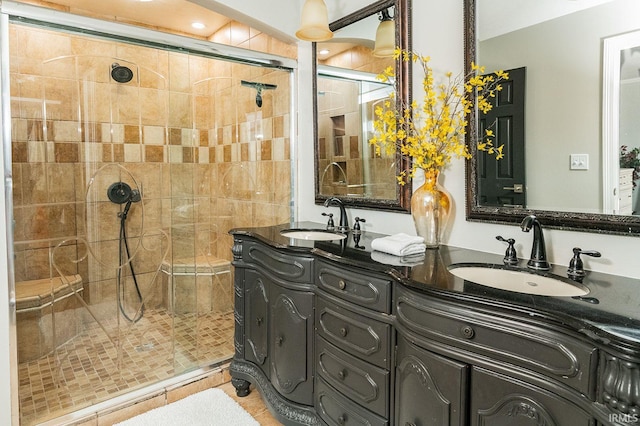 bathroom with tile patterned flooring, vanity, and a shower with door