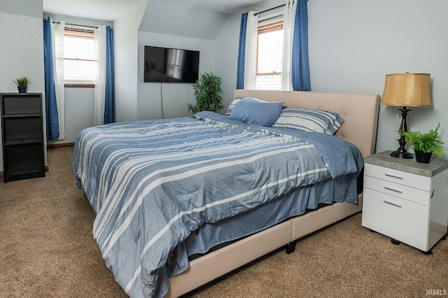 carpeted bedroom featuring lofted ceiling