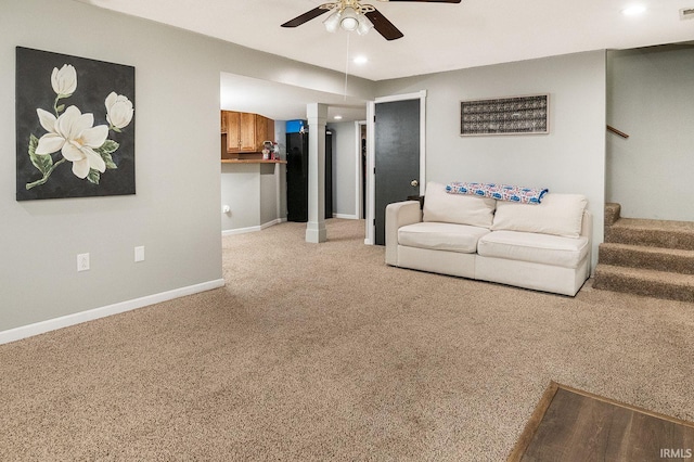 carpeted living room with ceiling fan