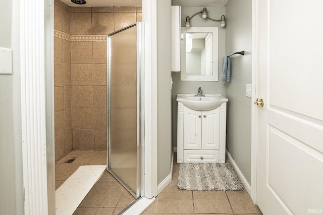 bathroom featuring tiled shower, vanity, and tile patterned floors