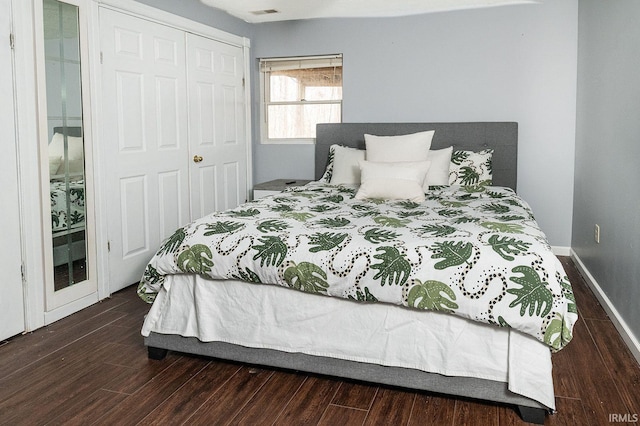 bedroom featuring a closet and dark wood-type flooring