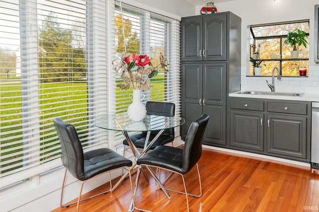 dining space with sink and light hardwood / wood-style flooring