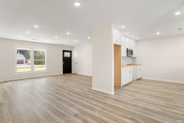 unfurnished living room featuring light wood-type flooring