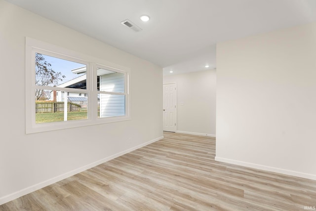 unfurnished room with light wood-type flooring