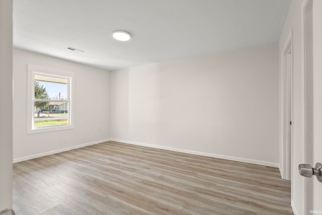 empty room with light hardwood / wood-style flooring