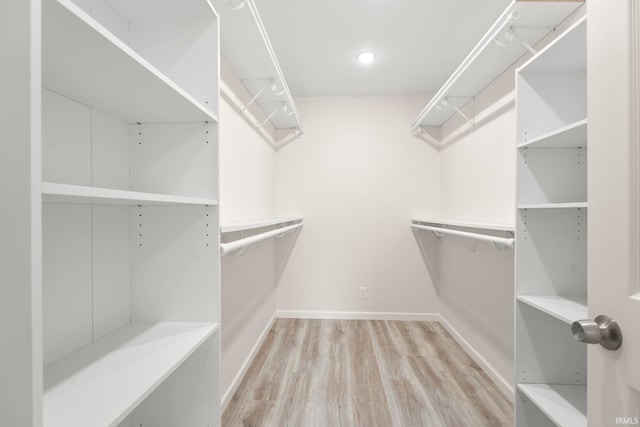 spacious closet with light hardwood / wood-style flooring