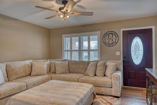 living room featuring hardwood / wood-style flooring, ceiling fan, and a wealth of natural light