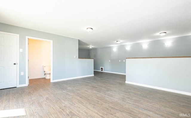 empty room with dark hardwood / wood-style flooring