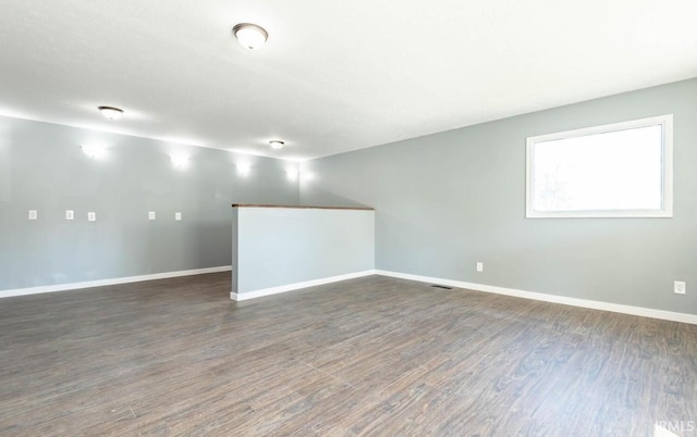 spare room with dark wood-type flooring