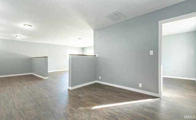 spare room featuring dark hardwood / wood-style flooring