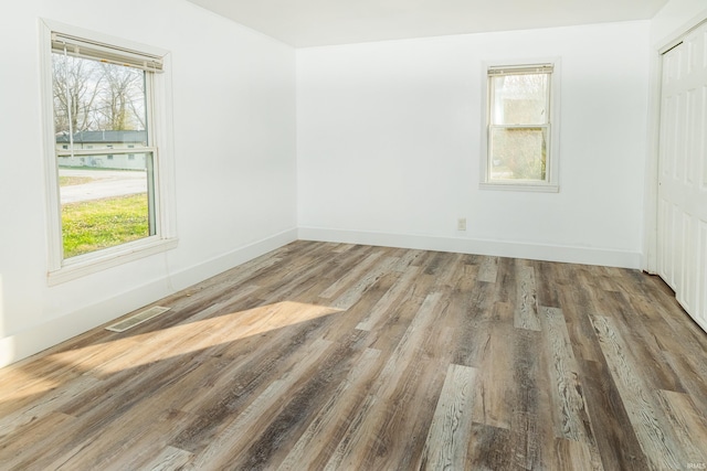 spare room with wood-type flooring