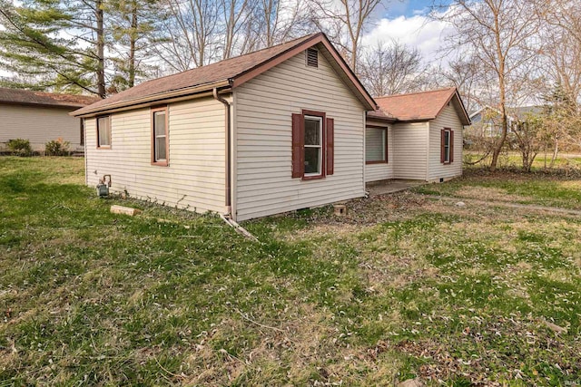 view of side of property with a yard