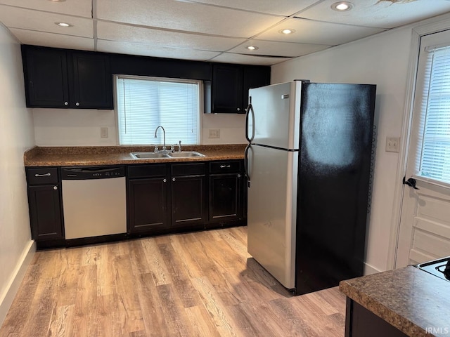 kitchen with appliances with stainless steel finishes, light hardwood / wood-style floors, and sink