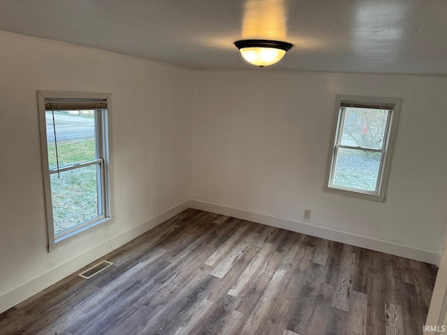 unfurnished room featuring dark hardwood / wood-style floors