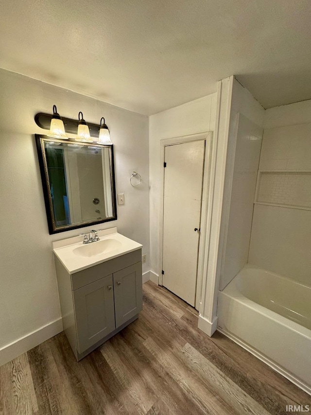 bathroom featuring vanity, wood-type flooring, and a textured ceiling