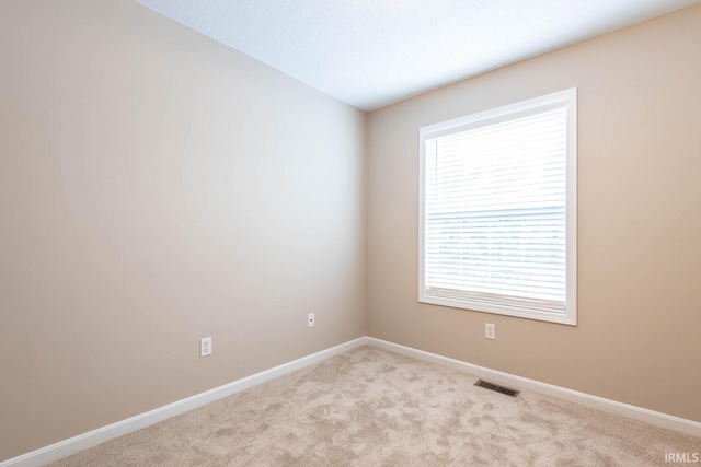 spare room with light colored carpet