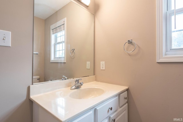 bathroom featuring vanity and toilet