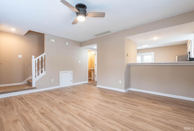 unfurnished living room featuring light wood-type flooring and ceiling fan