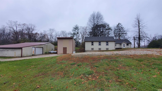 exterior space featuring a yard, an outdoor structure, and a garage