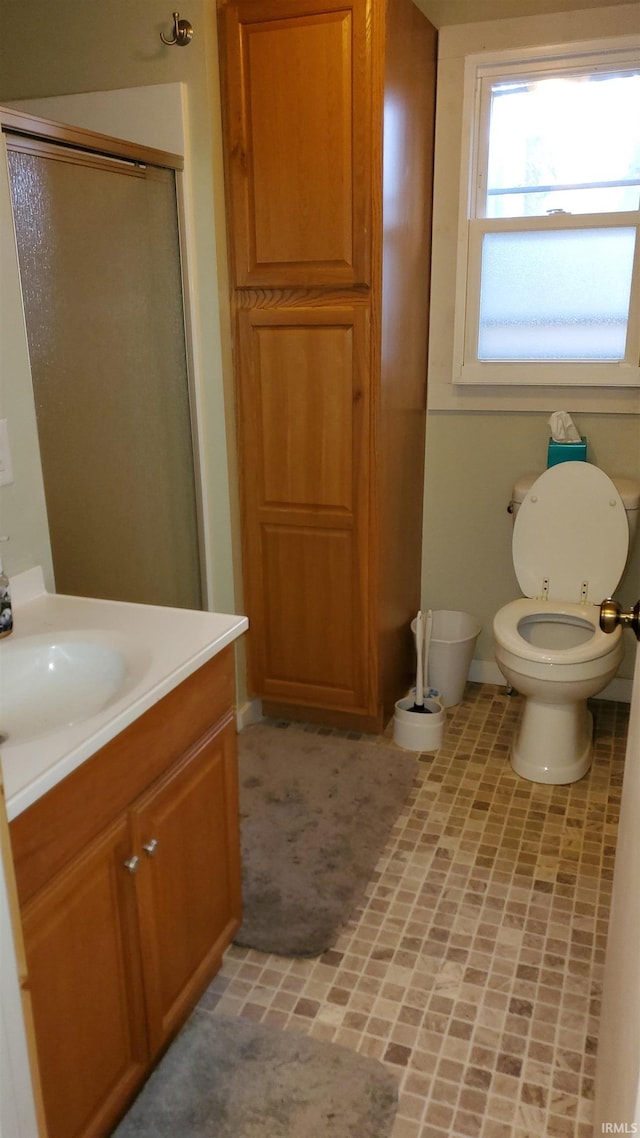 bathroom with vanity, toilet, and walk in shower