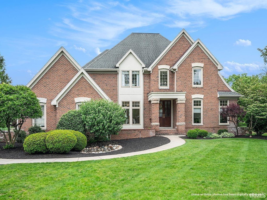 view of property featuring a front lawn