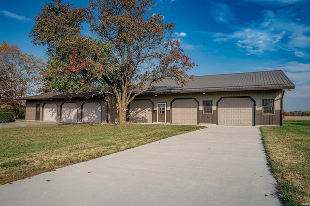 single story home featuring a garage and a front lawn