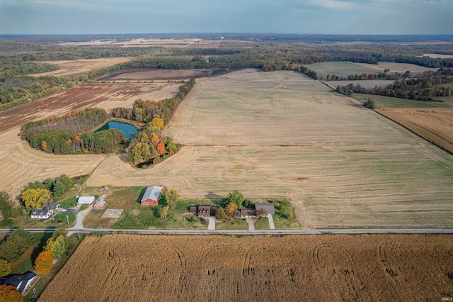 birds eye view of property featuring a water view and a rural view