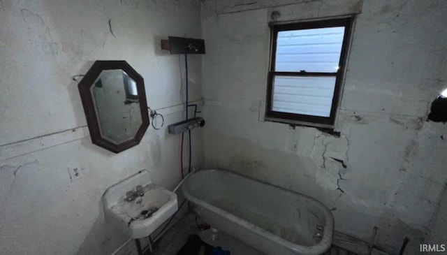 bathroom with toilet and a tub