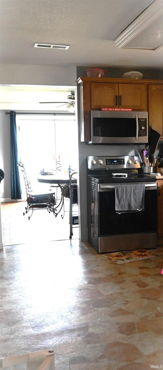 kitchen featuring a textured ceiling and stainless steel appliances