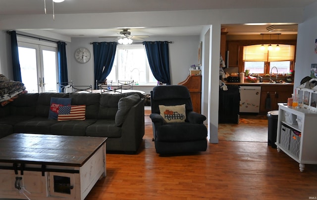 living room featuring hardwood / wood-style floors, french doors, a wealth of natural light, and ceiling fan