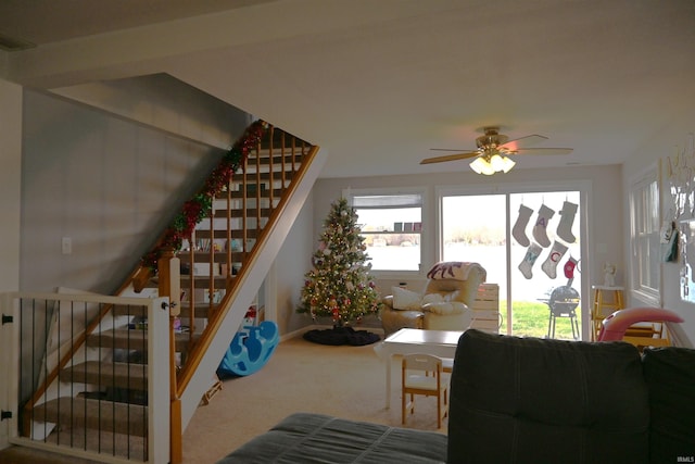 carpeted living room featuring ceiling fan